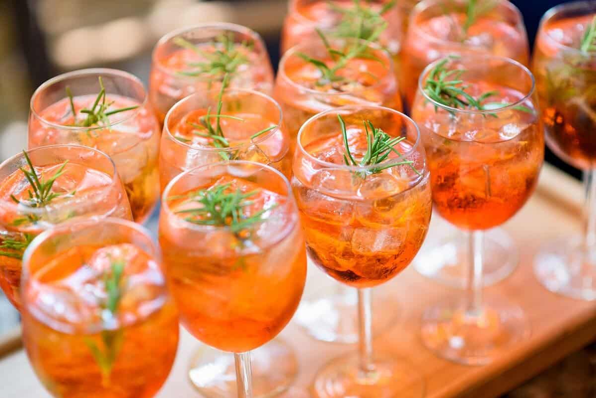 Chilled alcoholic cocktails served on the rocks with rosemary