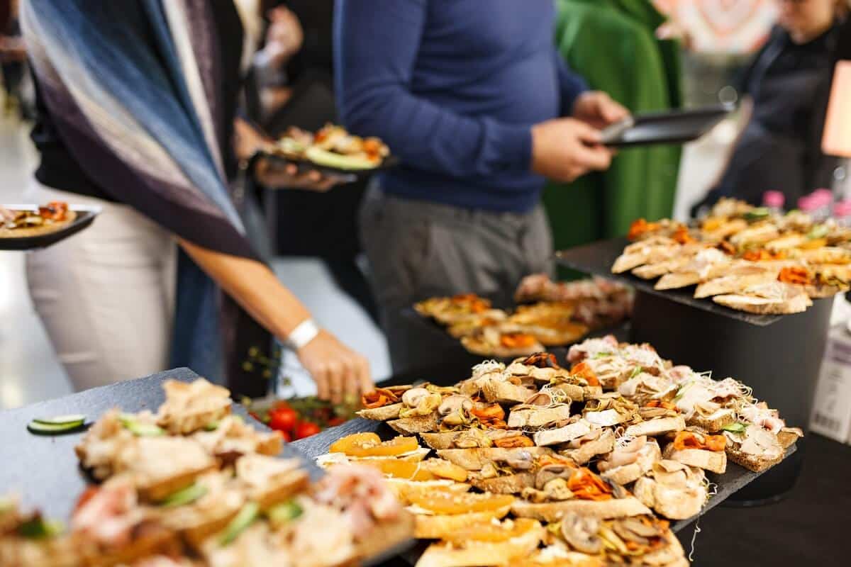 People grabbing sandwiches at a corporate event