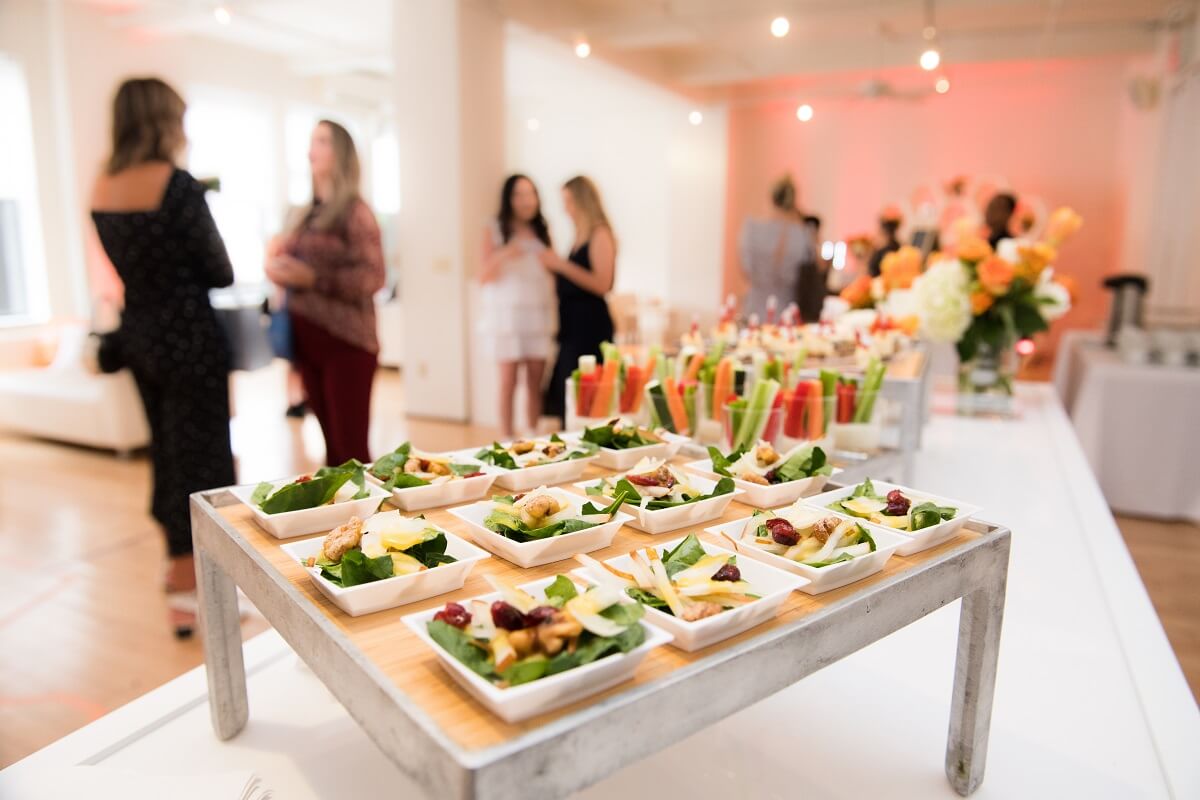 Food at a corporate event and participants in the background